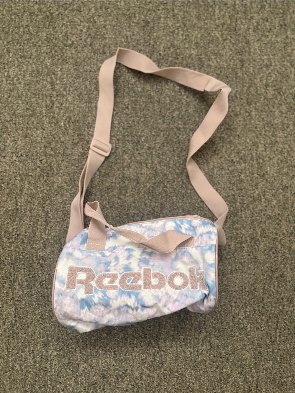 Reebok Women’s Pastel Tie-Dye Mini Crossbody Gym Duffle Bag in Pink and Blue.